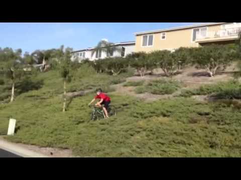 Kid eats pavement on mountain bike