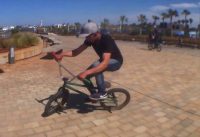 Riding BMX freestyle on street